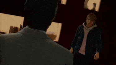 a man in a suit and a man in a pink sweatshirt are standing next to each other