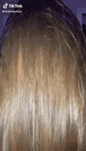 a close up of a woman 's hair with tik tok written on the bottom
