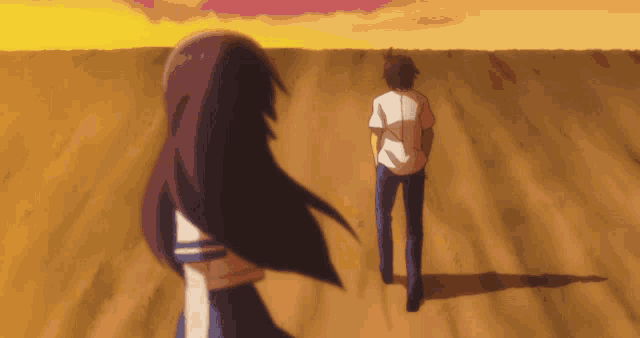 a man and a woman are walking through a field