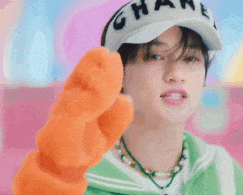 a young man wearing a hat that says chanel on it