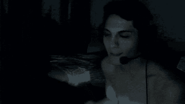 a woman without a shirt is wearing a headset