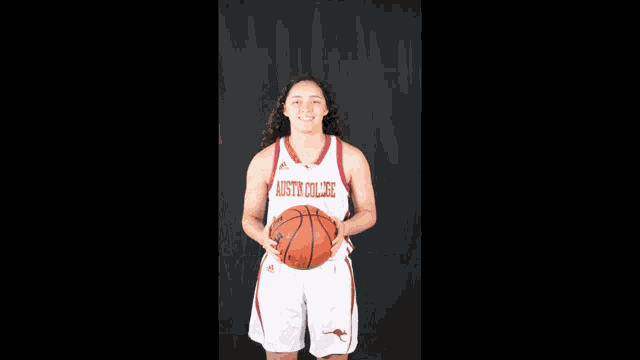 a female basketball player with a jersey that says austin college