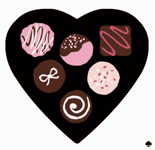 a heart shaped box filled with different types of chocolate