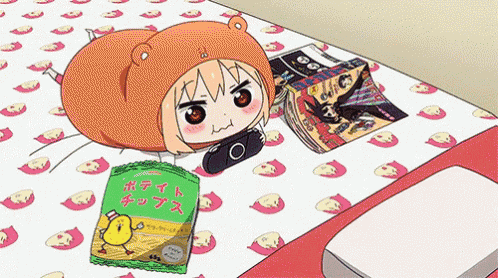 a cartoon character is laying on a bed next to a bag of chips and magazines .