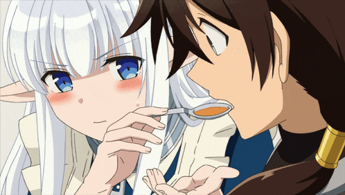 a man is feeding a woman a spoon of something
