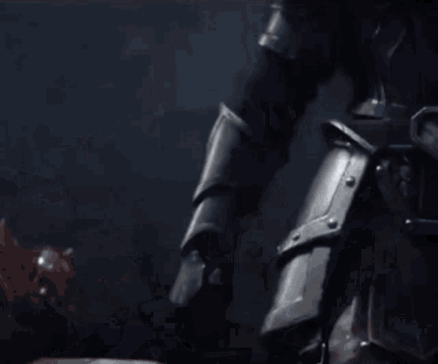 a close up of a person holding a sword in their right hand