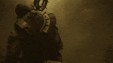 a statue of a demon with horns is surrounded by a glowing light