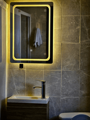 a bathroom with a sink and a mirror that says ' o ' on it