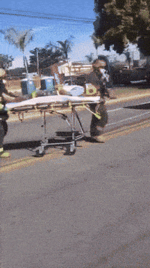 a person is on a stretcher on the side of a road