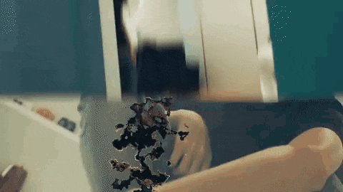 a person is washing their hands in a sink and a spider is coming out of their hand .
