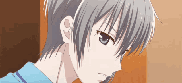 a close up of a person 's face with short hair and blue eyes