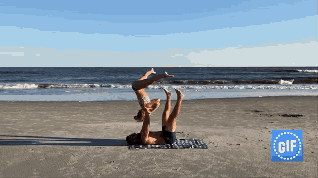 a man and a woman are doing yoga on a beach with a gif logo in the background