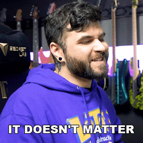 a man with a beard wearing a purple hoodie that says " it does n't matter "