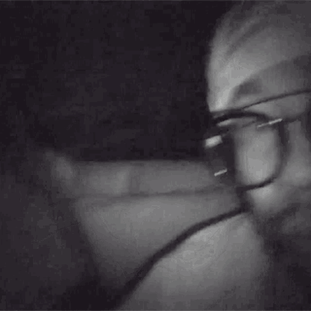 a person wearing glasses is making a funny face