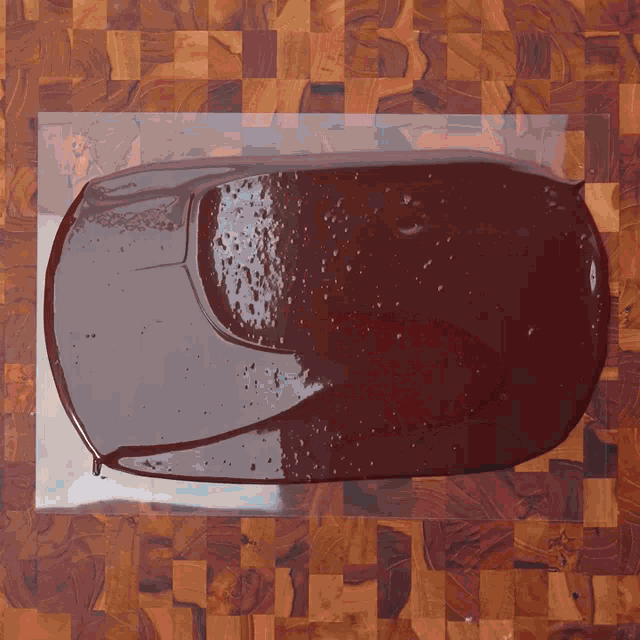 a piece of chocolate on a wooden cutting board
