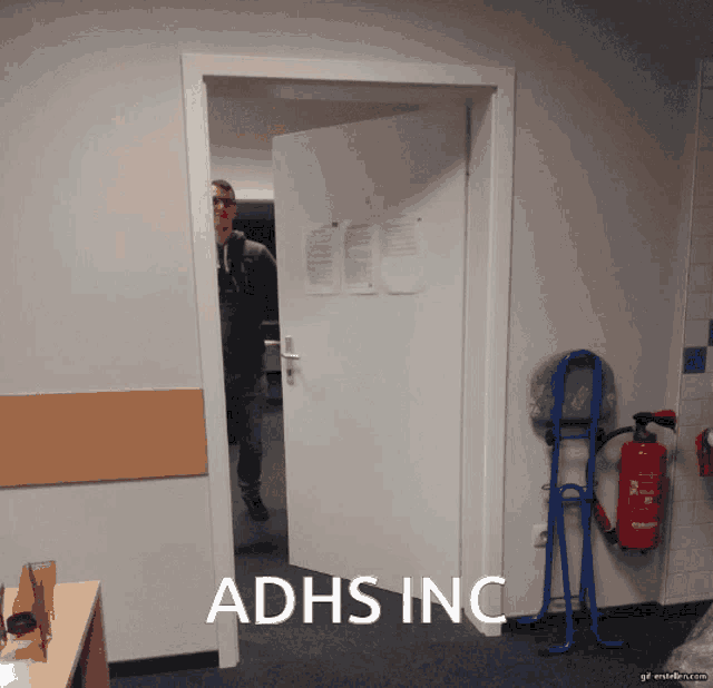 a man standing in a doorway with adhs inc written on the bottom