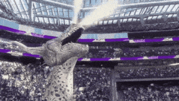 a statue of a dragon is standing in a stadium with its mouth open .