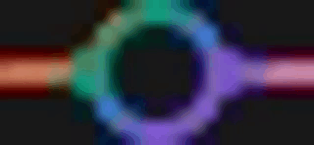 a rainbow colored circle on a black background with a circle in the middle .