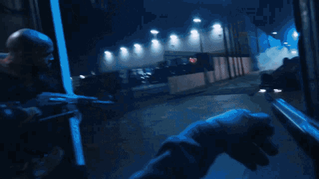 a blurry picture of a man holding a sword and a car behind him