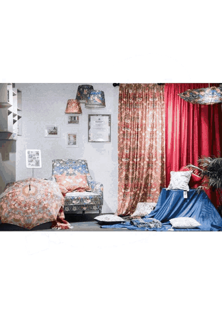a room with a red curtain and a chair with a floral pattern on it