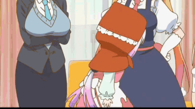 a woman in a suit and tie is standing next to a girl in a pink dress