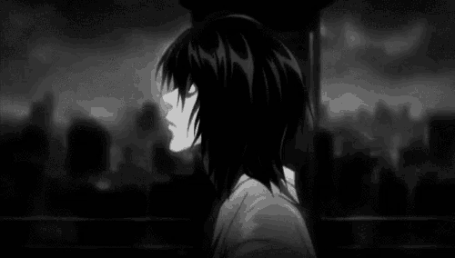 a black and white photo of a person with long hair standing in front of a city