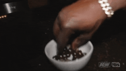 a person pouring something into a bowl that says aew tbs on the bottom