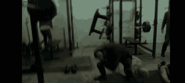 a blurred image of people in a gym with a chair falling