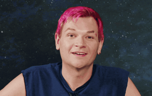 a man with pink hair says " i 've taken control " in front of a starry sky