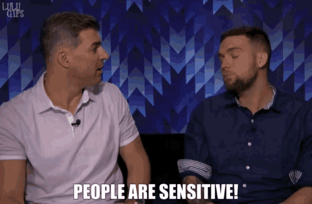 two men sitting next to each other with the words people are sensitive
