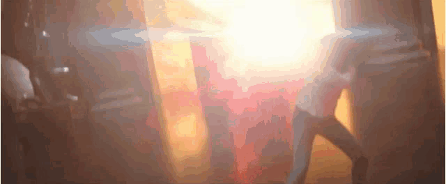 a blurred image of a person standing in front of a window