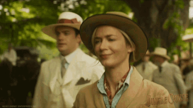 a woman wearing a hat with the word jungle cruise on the bottom right