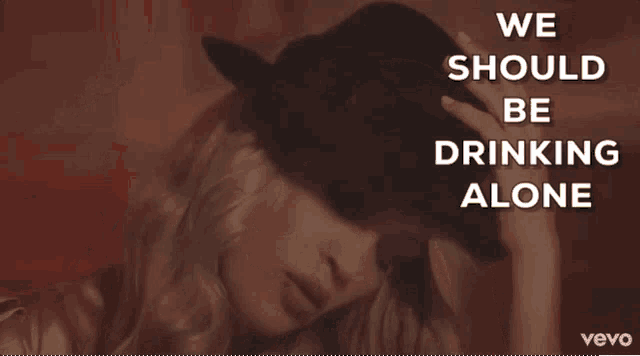 a woman wearing a hat with the words " we should be drinking alone " above her