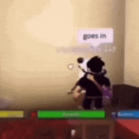 a blurry picture of a person in a room with a sign that says `` goes in '' .