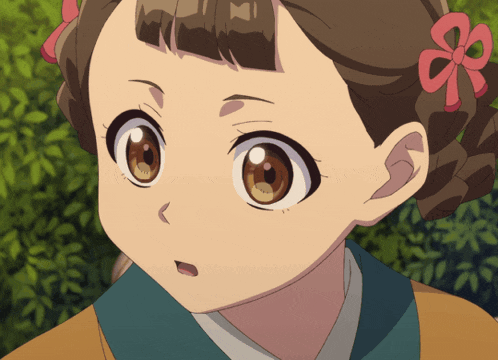 a close up of a girl 's face with a bow in her hair