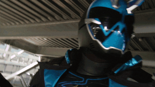 a close up of a person wearing a blue and black helmet