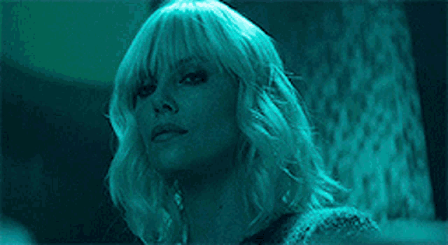 a close up of a woman 's face in a dark room