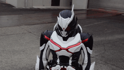 a black and white robot with a red x on his chest