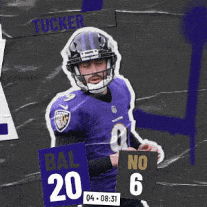 a football player in a purple uniform is holding a sign that says bal 20