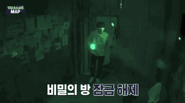 a man is standing in a dark room holding a flashlight in his hand .