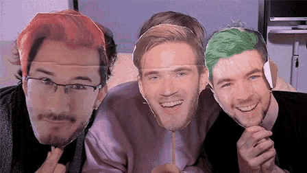 a group of three men are posing for a picture with their faces on a stick .