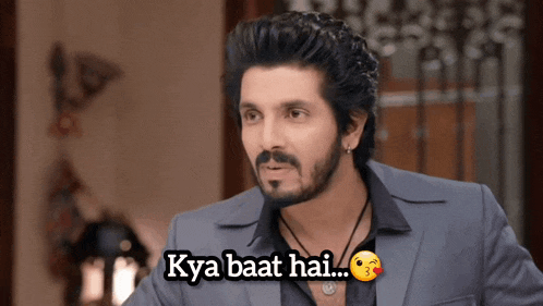 a man with a beard and mustache is wearing a suit and a black shirt with the caption kya baat hai