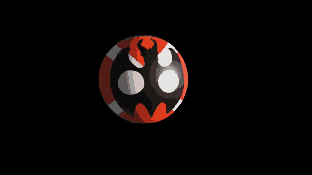a red and black ball with a black and white circle in the middle
