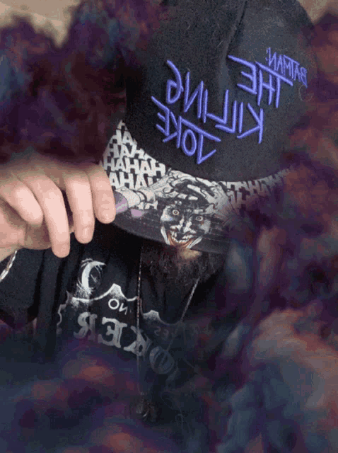 a man with a beard wearing a hat that says the killing joke