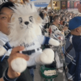 a man is holding a stuffed animal that has lions on it