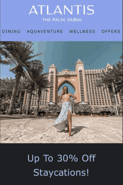 an ad for atlantis the palm dubai shows a woman standing on the beach