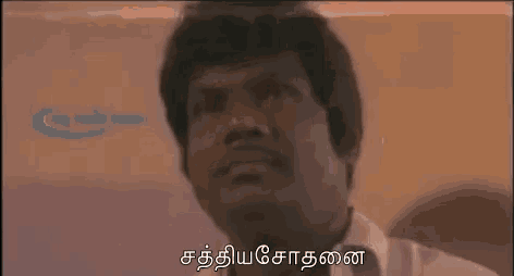 a close up of a man 's face with a foreign language behind him .