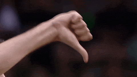 a close up of a person giving a thumbs down