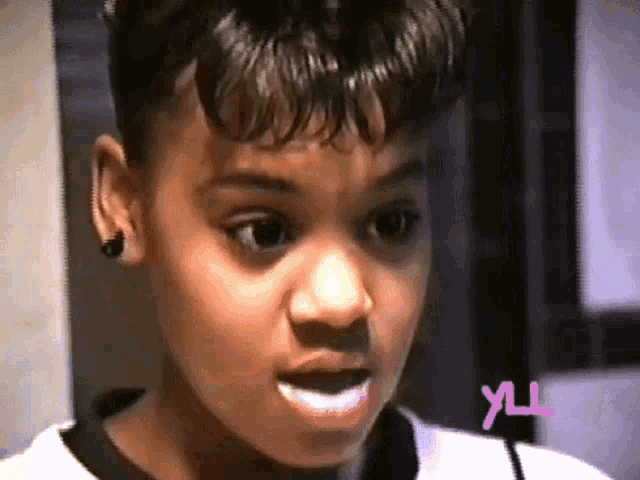 a close up of a young girl 's face with the letters yul on the bottom
