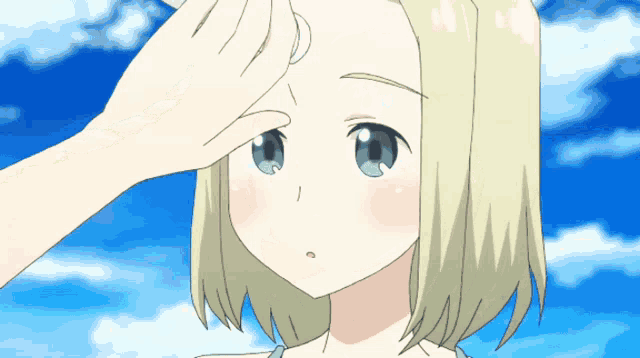 a girl with blonde hair and blue eyes is being touched by a hand